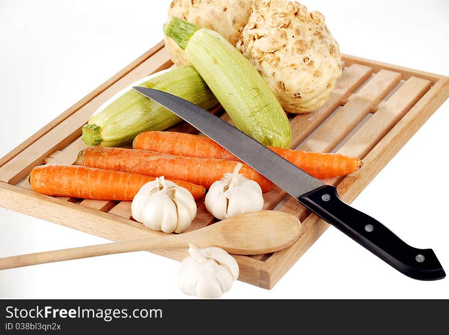 Vegetable mix and knife on a wooden plate