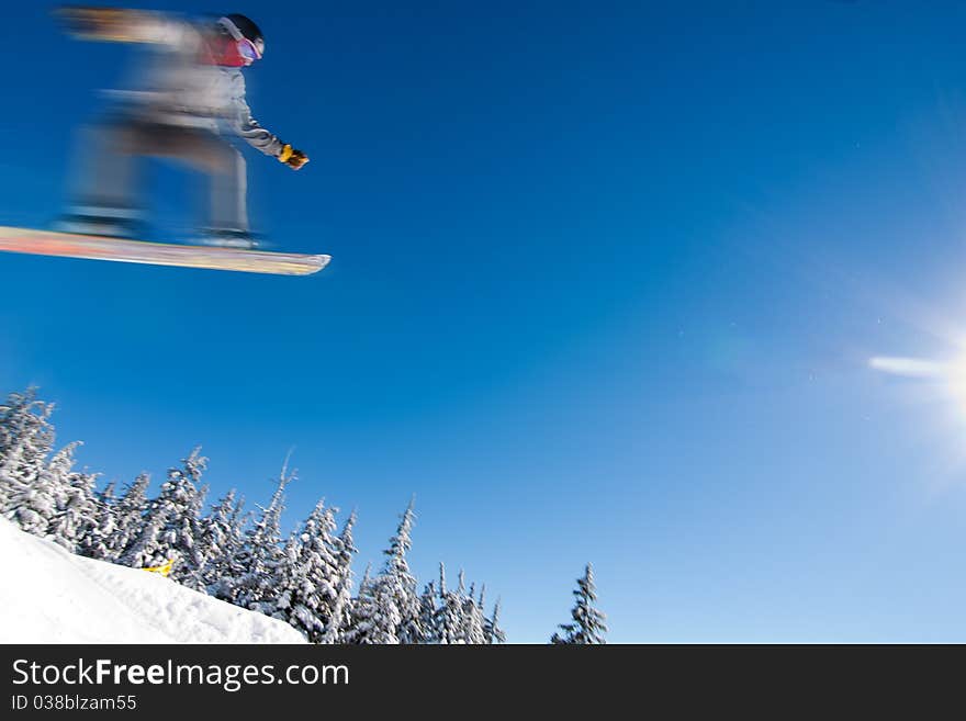 Male Snowboarder Catches Big Air.