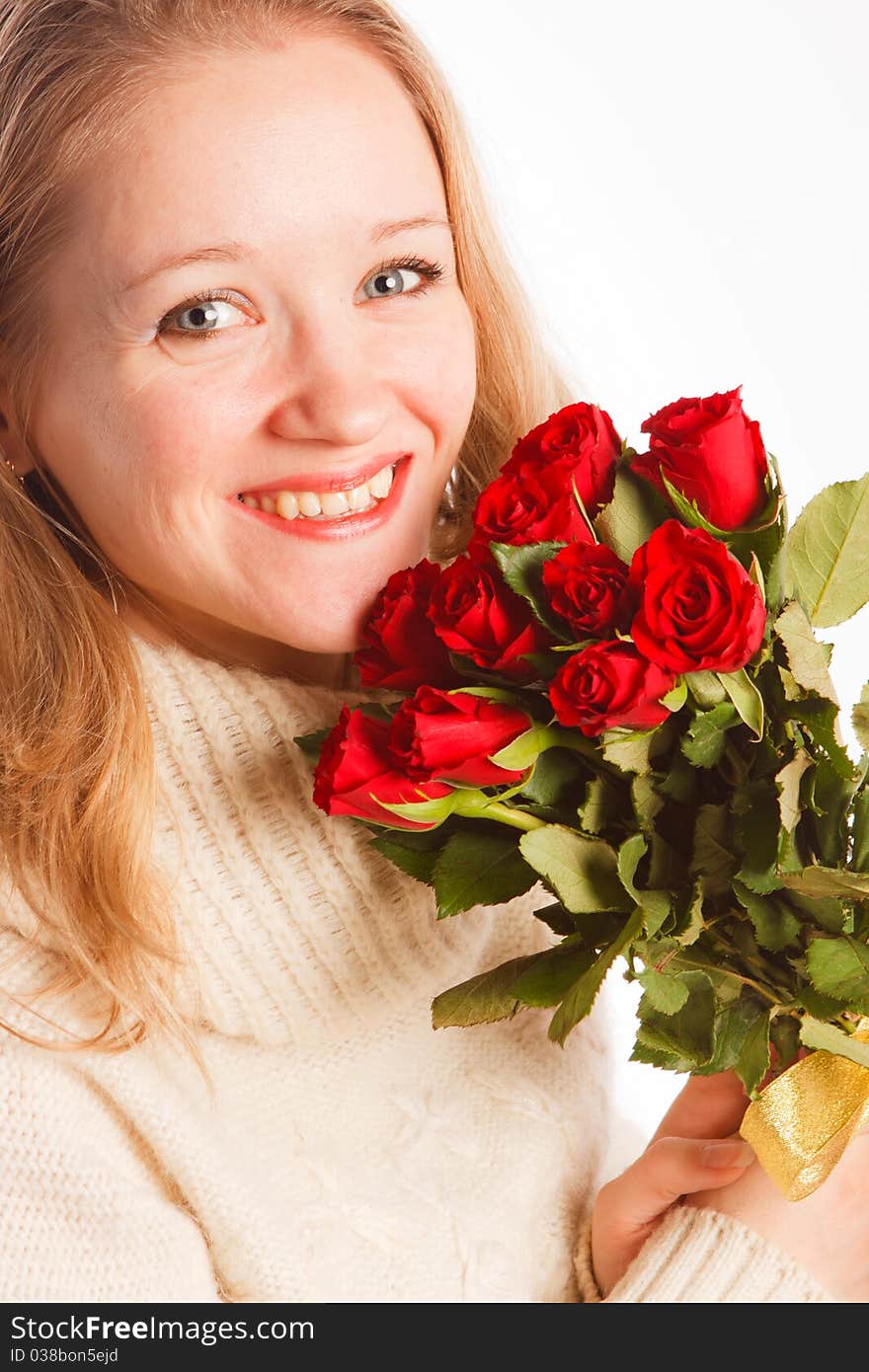 Beautiful young woman with the bouquet of red roses