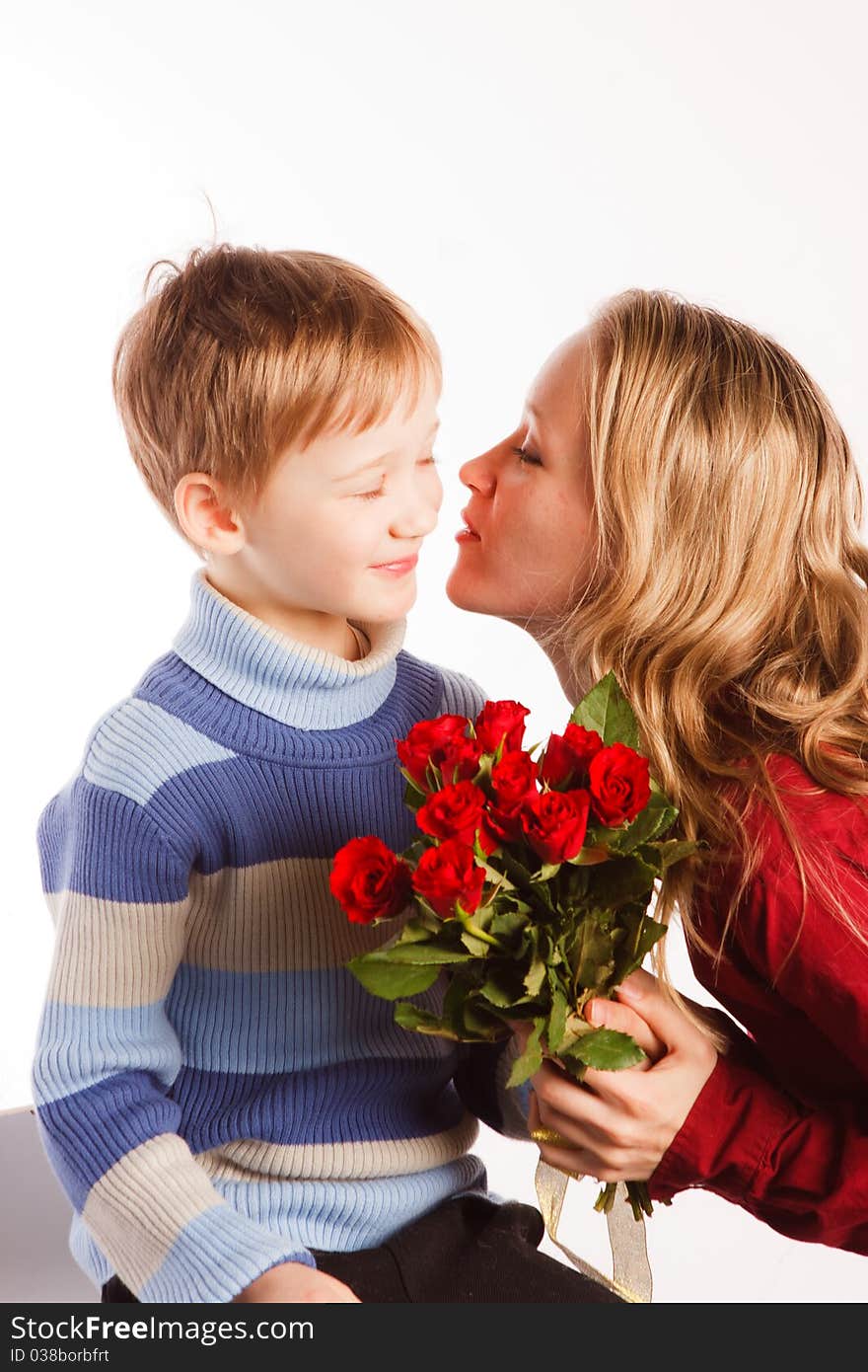 Charming beautiful young woman with a son and with the bouquet of red roses on a white background