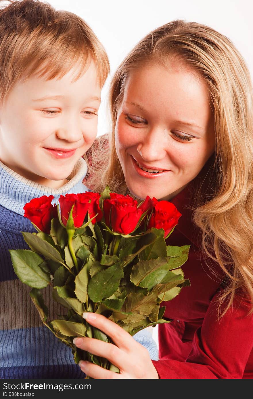 Charming  beautiful young woman with a son and with the bouquet of red roses on a white background