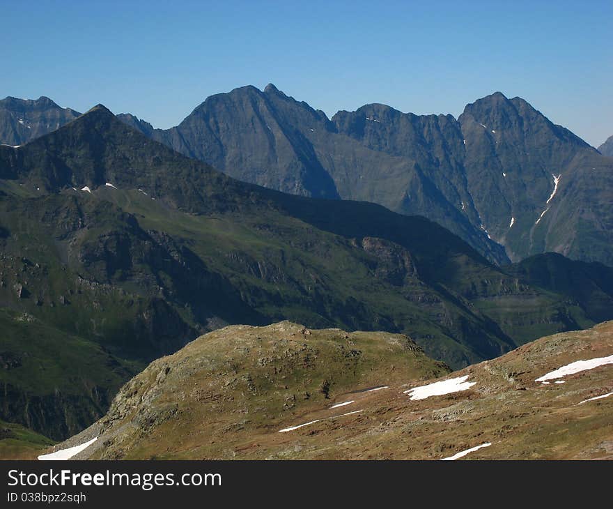 Sharp peaks of high rocky black mountains. Sharp peaks of high rocky black mountains