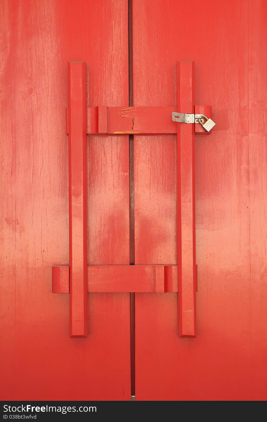 Red door of church with wood latch