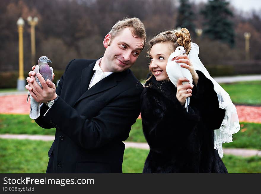 Bride and groom with pigeons on hands