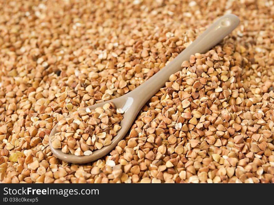 Buckwheat in little brown spoon. Buckwheat in little brown spoon