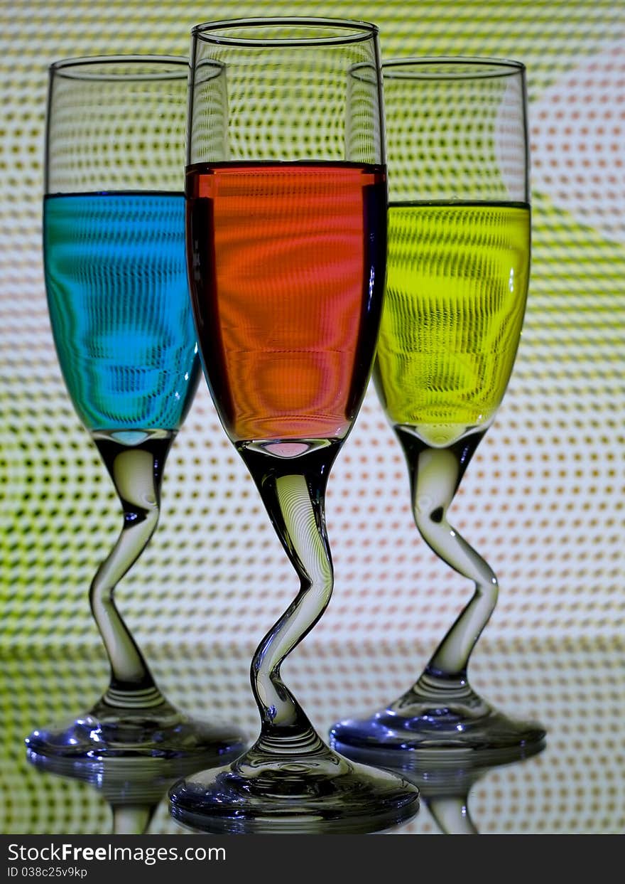 Curved glasses of colored ligueur