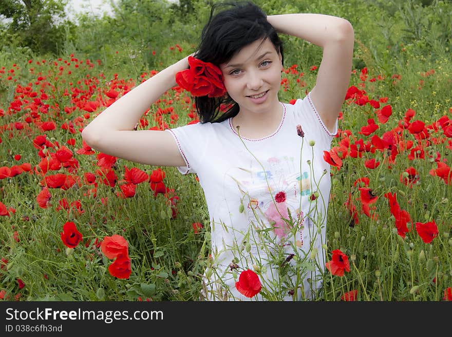 Young Black Hair Girl in red poppies field