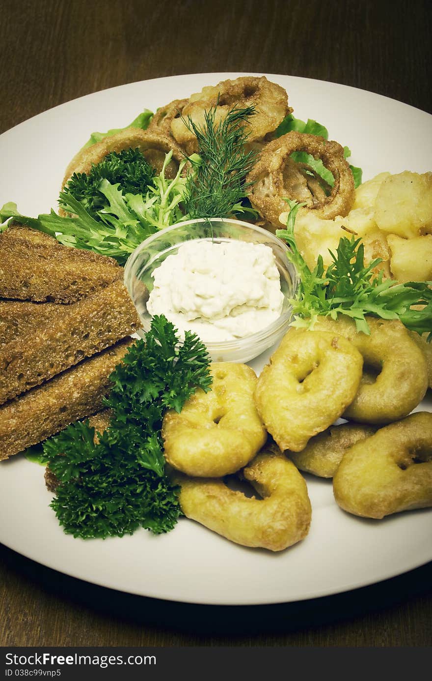 Appetizer made of fried onion, potato and bread. Appetizer made of fried onion, potato and bread