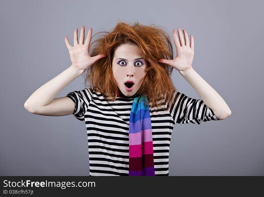 Angry girl with funny hair. Studio shot.