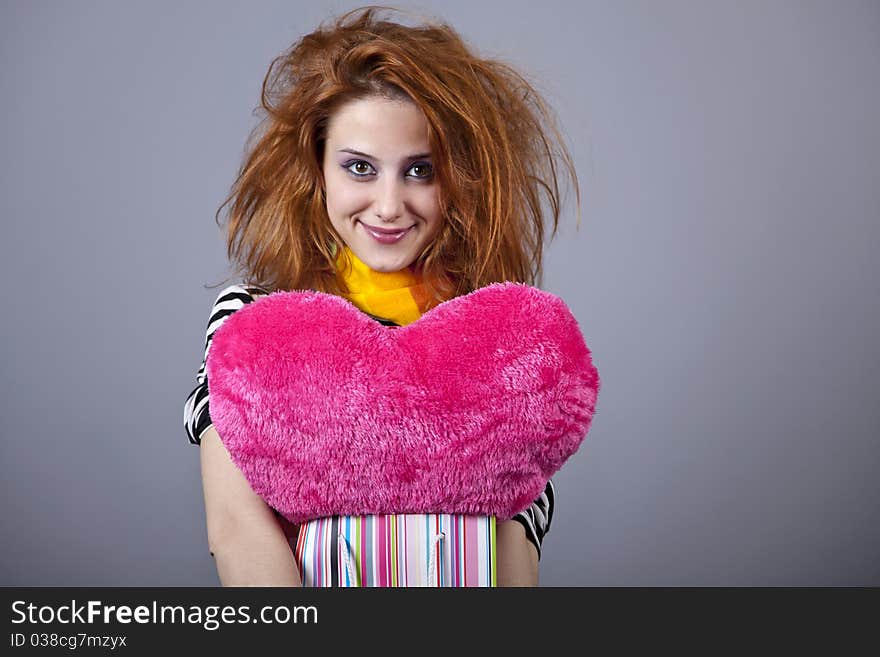 Funny girl with heart. Studio shot.