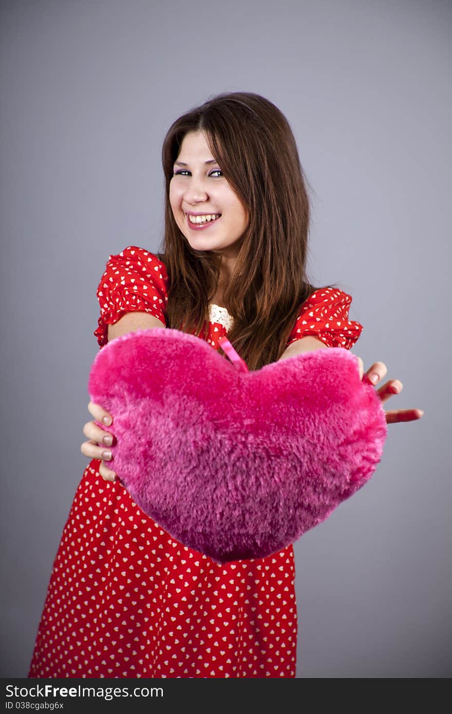 Beautiful girl with heart. Studio shot.