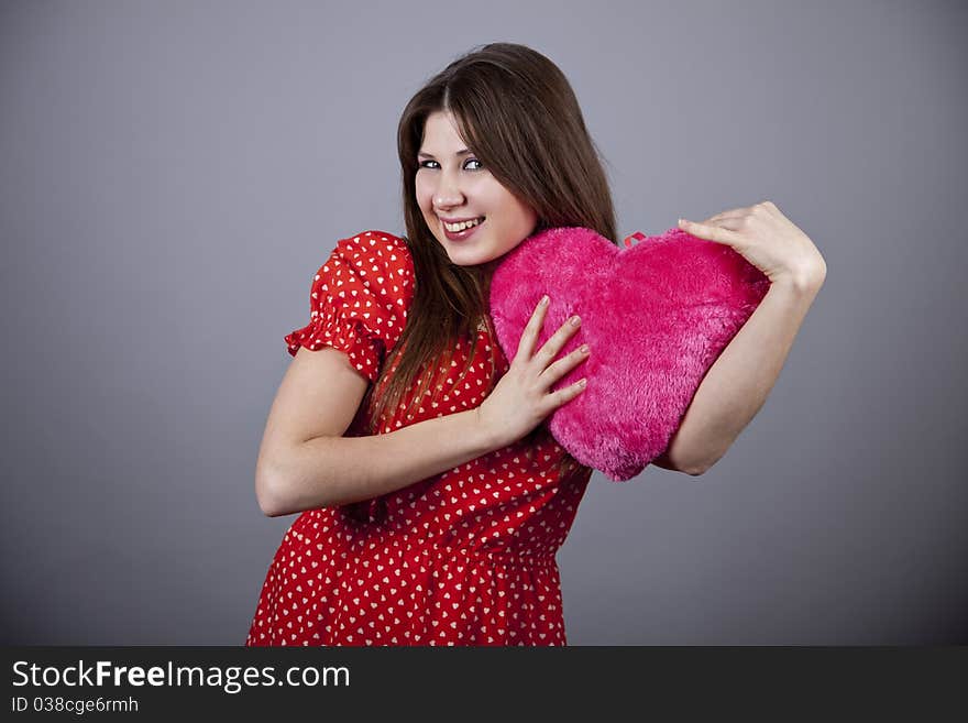 Beautiful girl with heart. Studio shot.