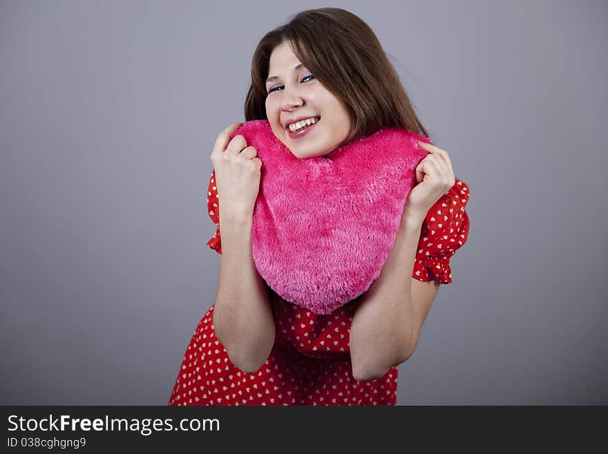 Beautiful girl with heart. Studio shot.