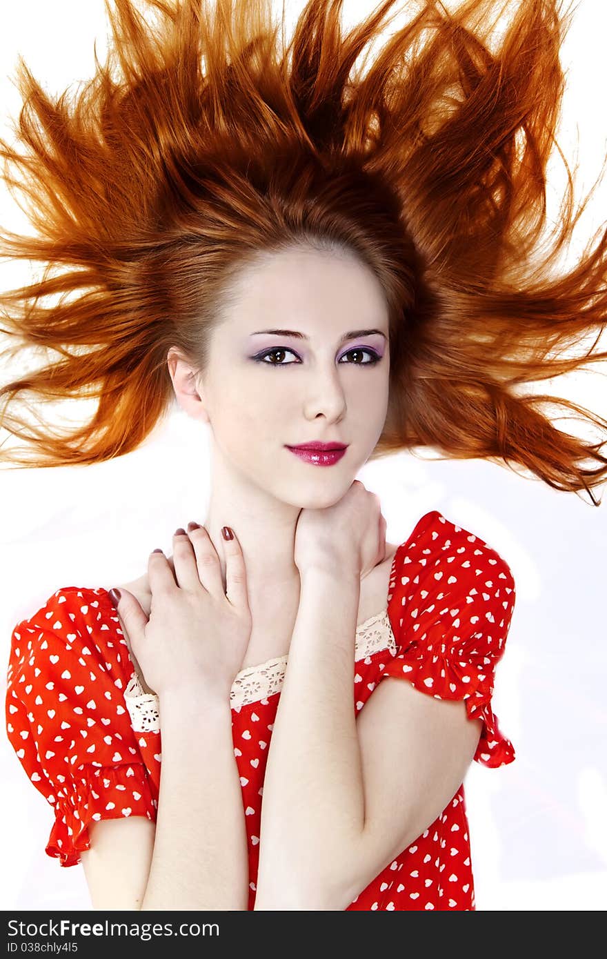 Red-haired girl in dress. Studio shot.