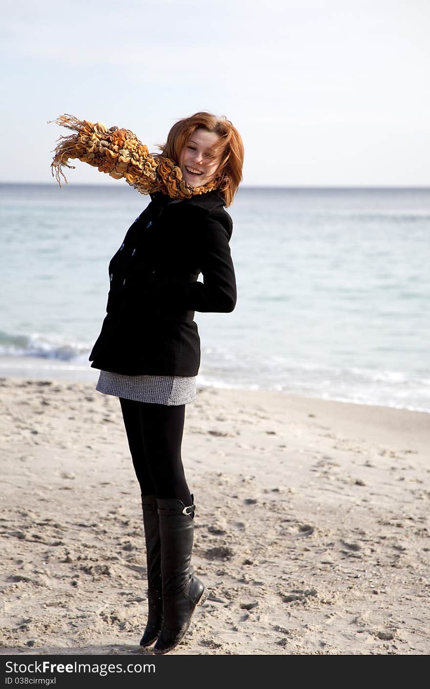 Red-haired girl at the beach. Outdoor shot.