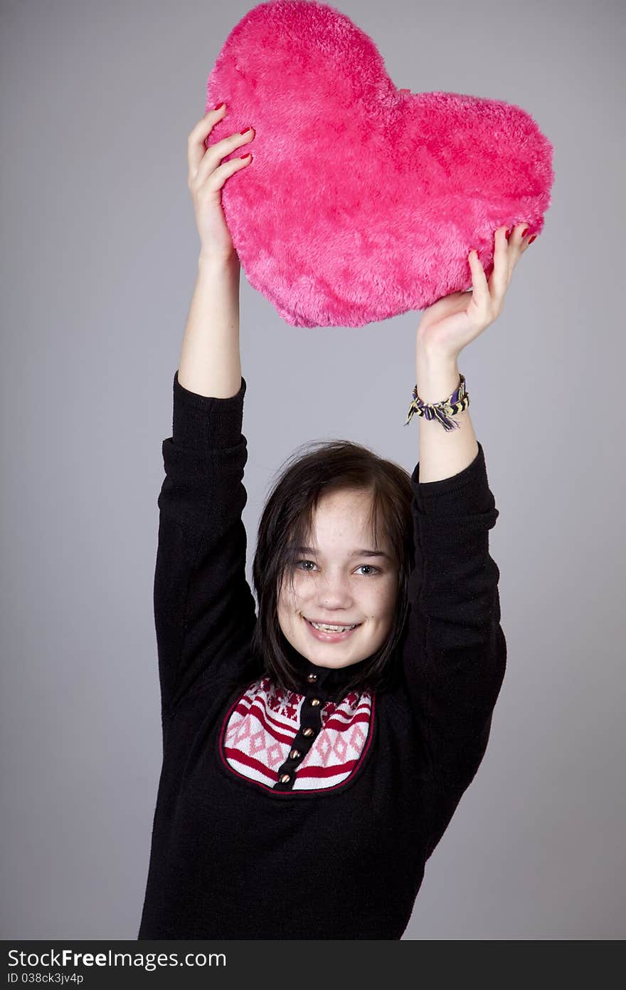 Funny gril with toy heart. Studio shot. Funny gril with toy heart. Studio shot.