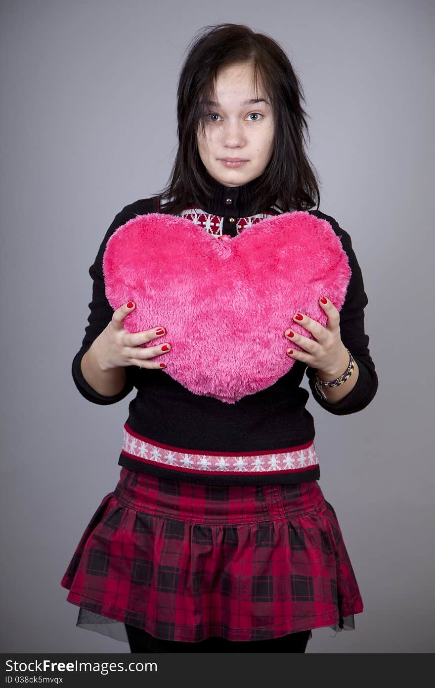 Funny gril with toy heart. Studio shot. Funny gril with toy heart. Studio shot.