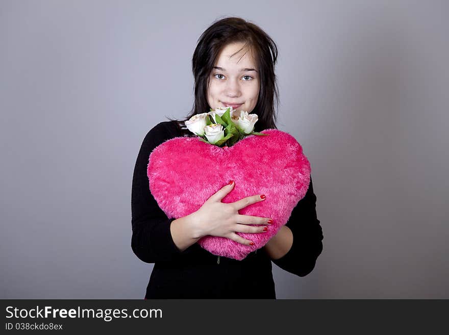 Funny gril with toy heart. Studio shot. Funny gril with toy heart. Studio shot.