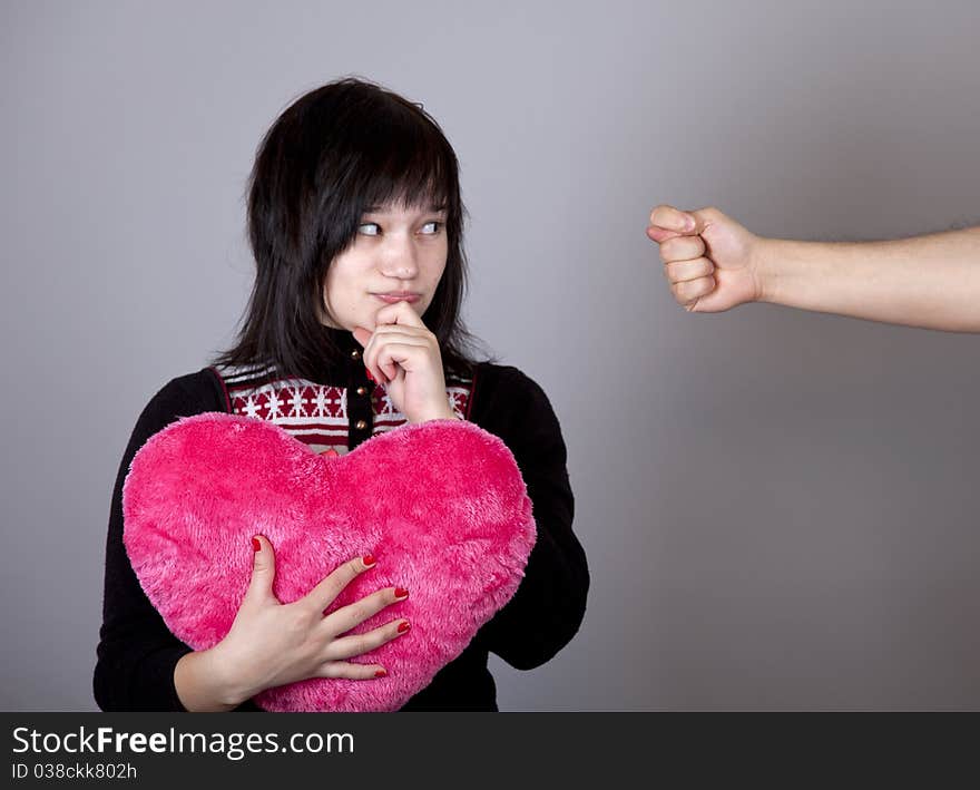 Funny girl with heart and fig. Studio shot.