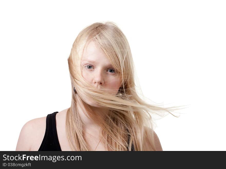 Blond hair is developing the wind on a white background