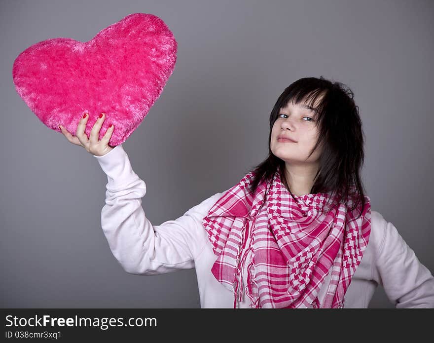 Funny gril with toy heart. Studio shot. Funny gril with toy heart. Studio shot.