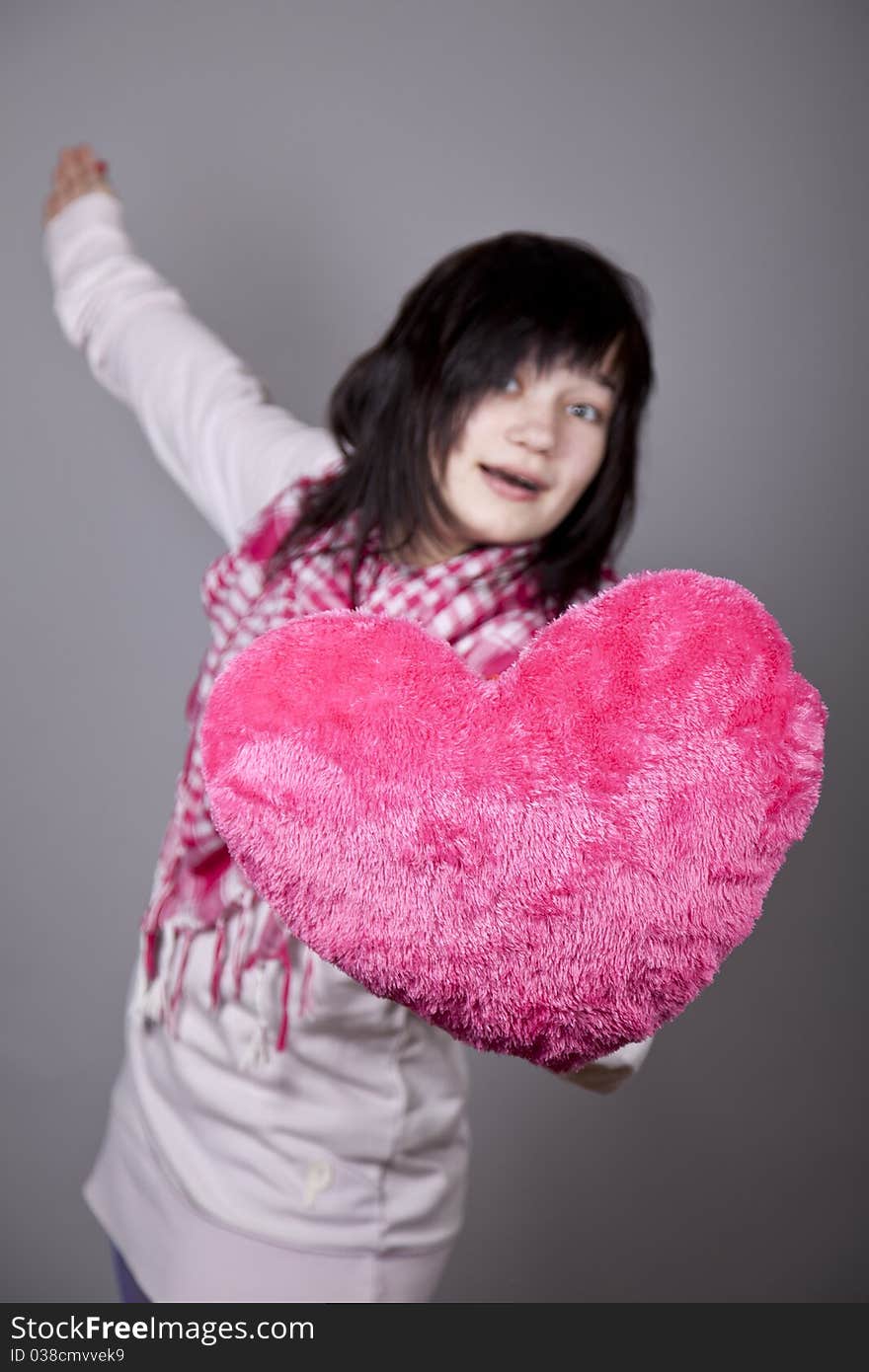 Funny gril with toy heart. Studio shot. Funny gril with toy heart. Studio shot.