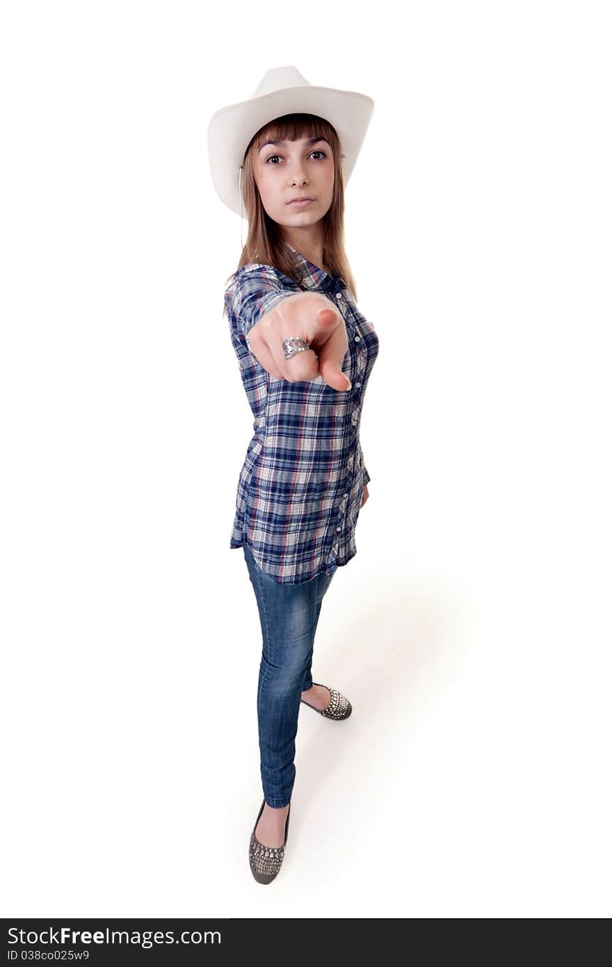 Girl in a hat shows his finger on a white background