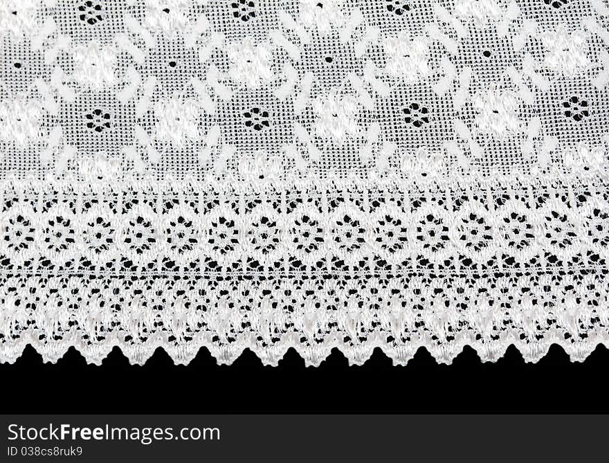 White lace with a floral pattern on a black background