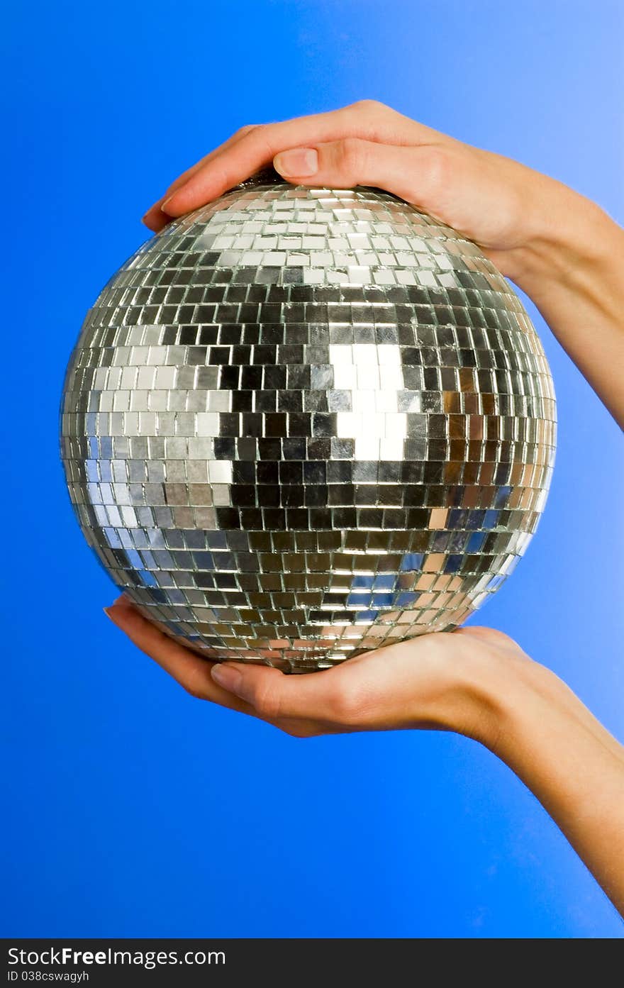 Mirror disco ball with reflections in hands. Mirror disco ball with reflections in hands