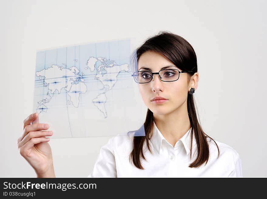 A girl with a map of the world printed on a transparent material