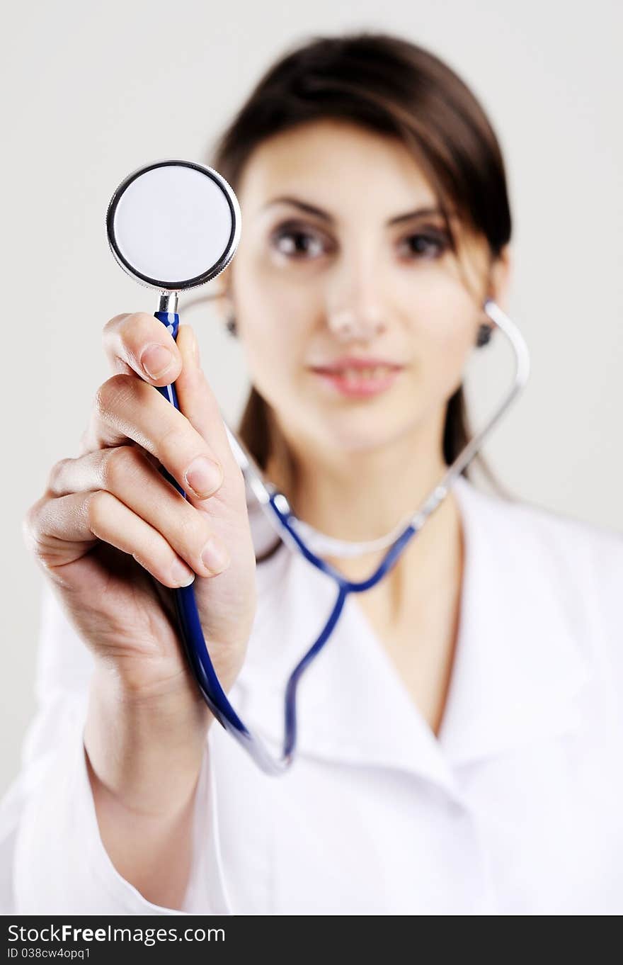 An image of young doctor holding stethoscope to camera. An image of young doctor holding stethoscope to camera