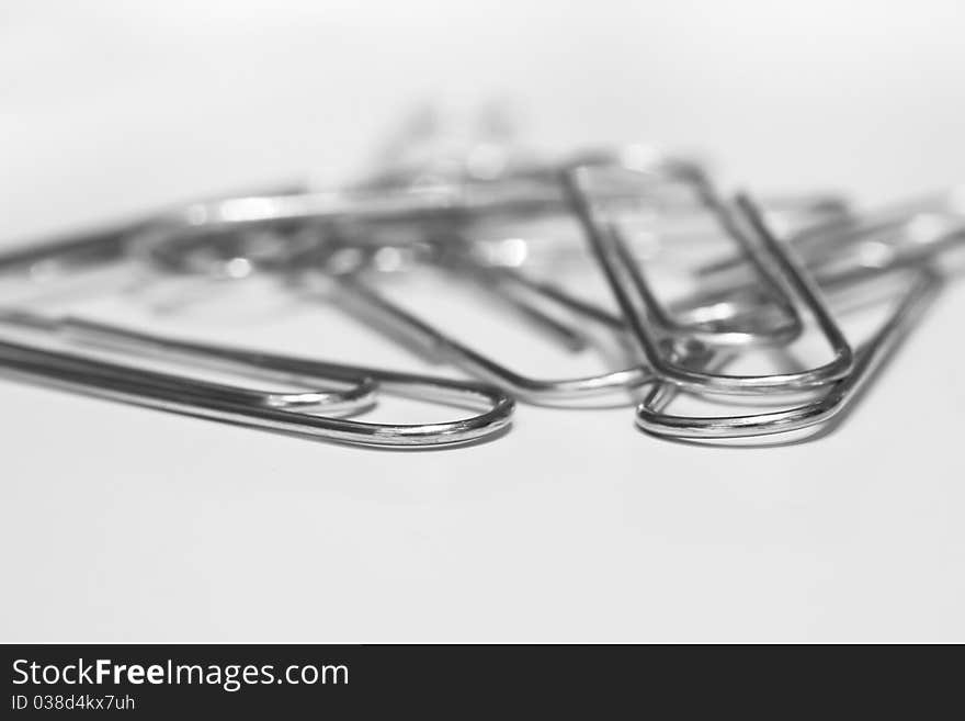 A closeup image of scattered paper clips