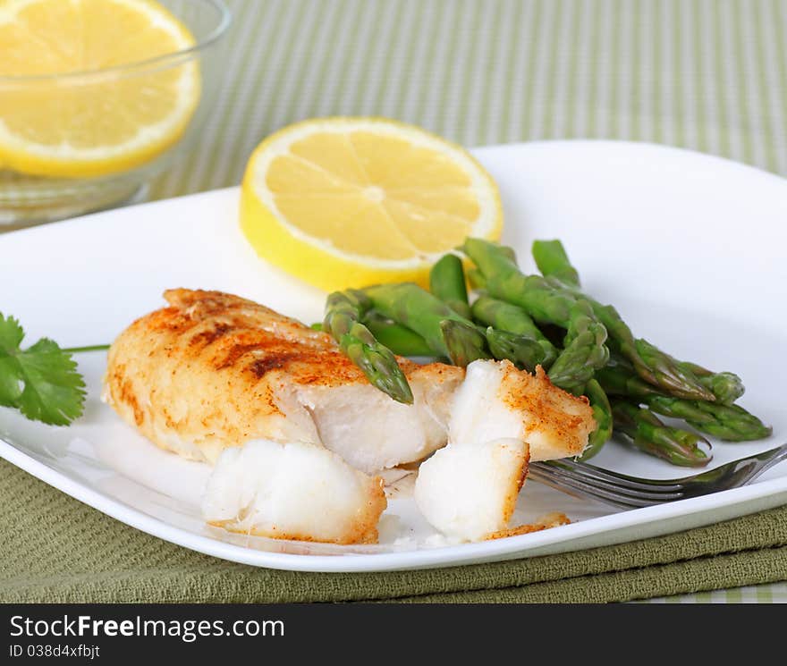 Fish fillet with asparagus and sliced lemon. Fish fillet with asparagus and sliced lemon