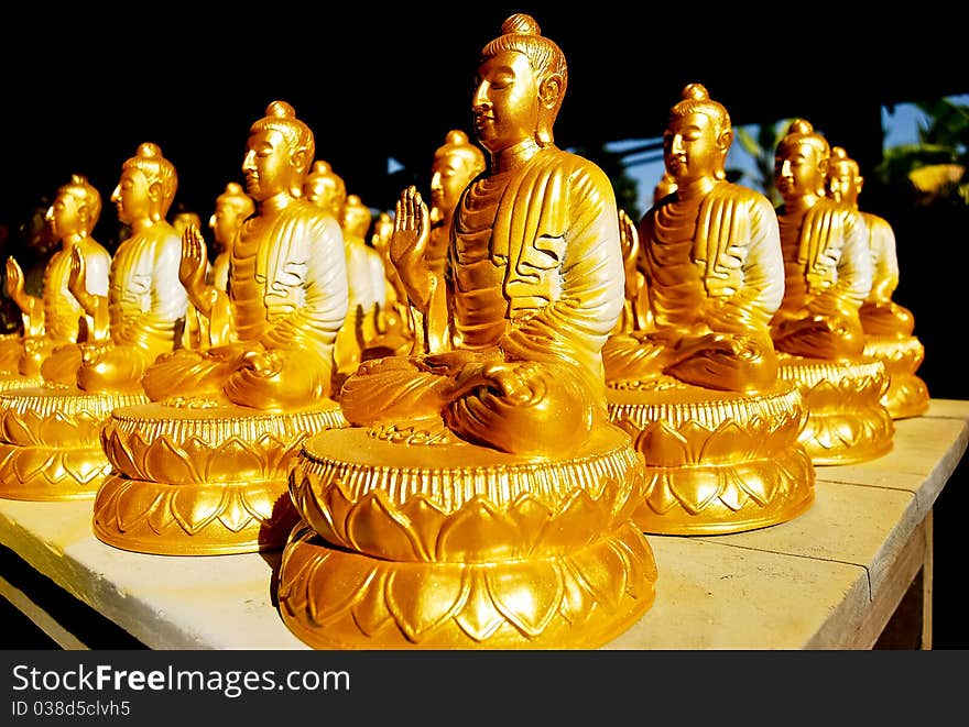 Many of Golden Buddha Statue meditation pose in Buddha Temple in Asia , Thailand