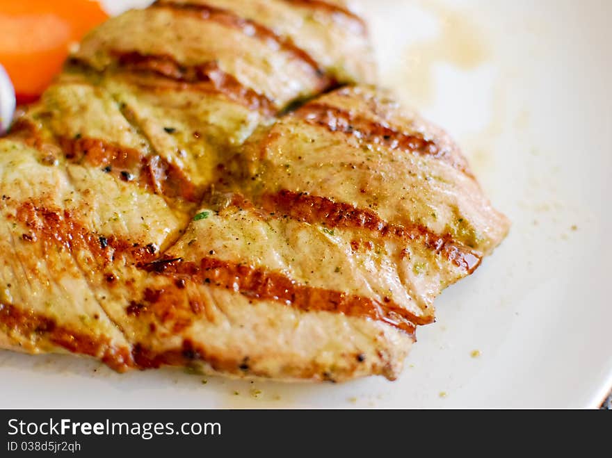 Grilled pork steak set with french fries and vegetable