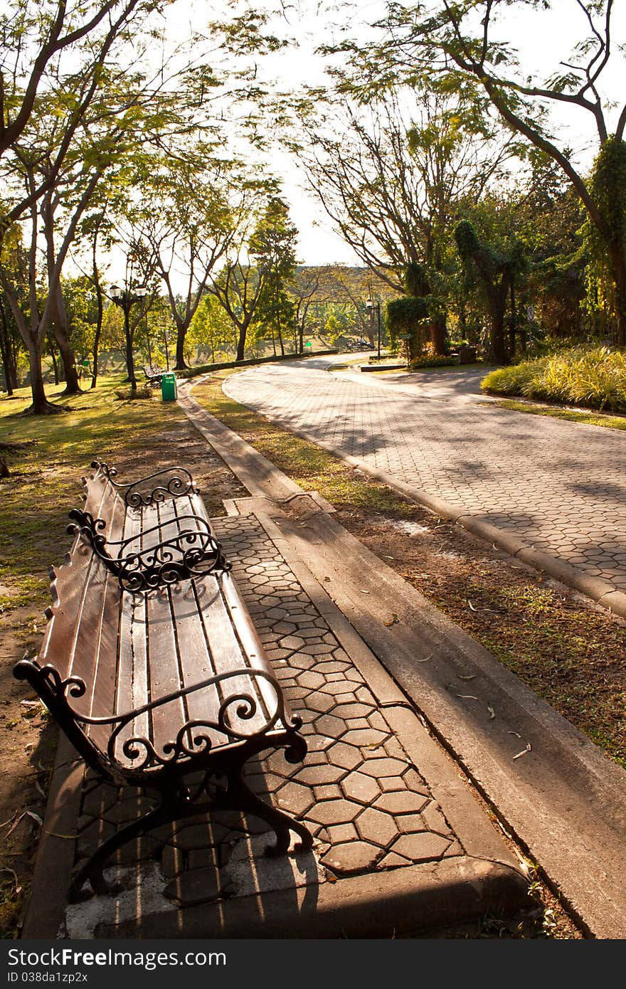 Bench in park at sunset