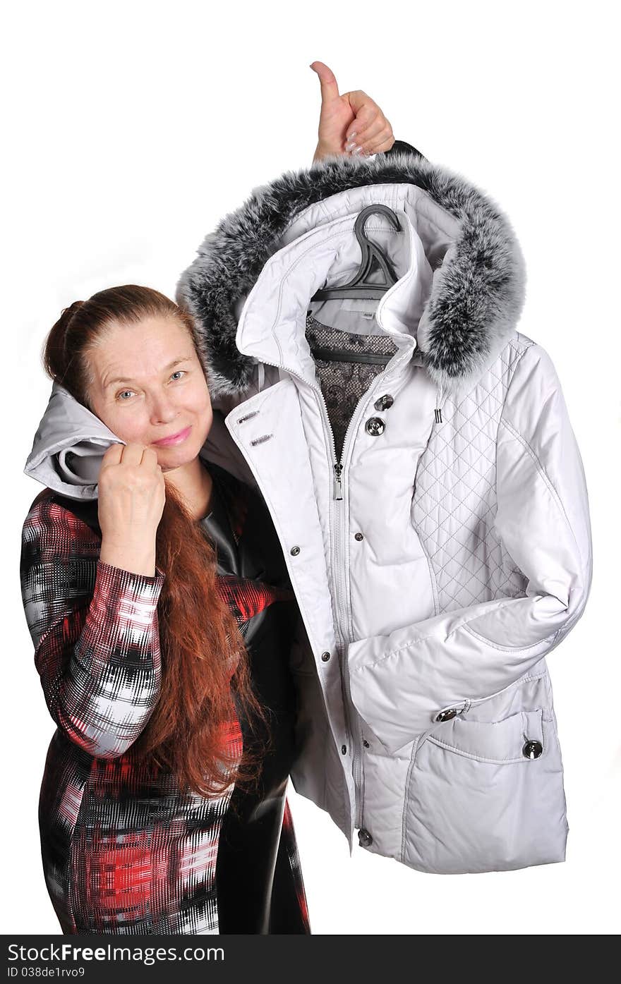 The elderly woman and new winter jacket with a fur collar. The elderly woman and new winter jacket with a fur collar.