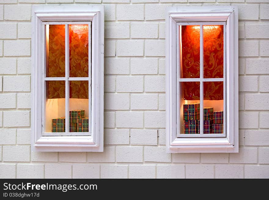 Pair of white window displaying some gift