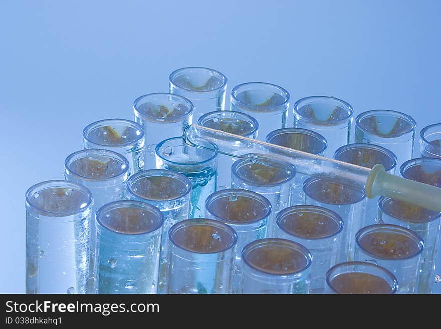 Pipette laying on a set of test tubes. Pipette laying on a set of test tubes.