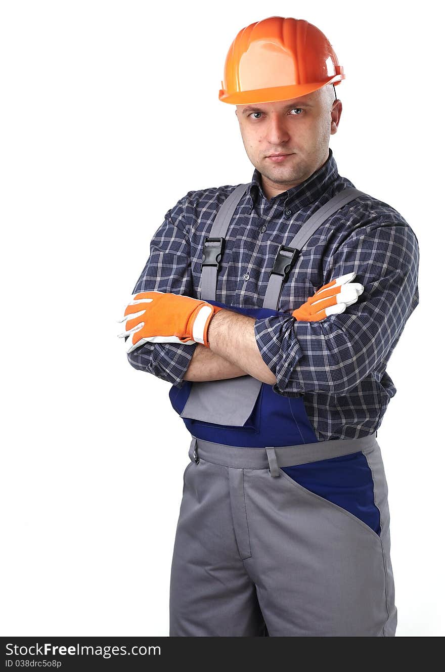 The man in the workers' clothes in 
a helmet on a white background. The man in the workers' clothes in 
a helmet on a white background