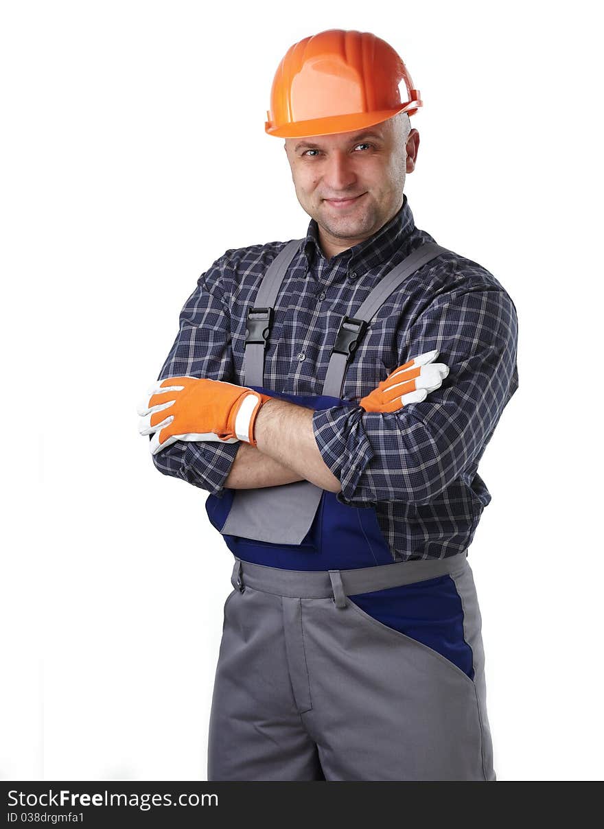 The man in the workers' clothes in a helmet on a white background. The man in the workers' clothes in a helmet on a white background