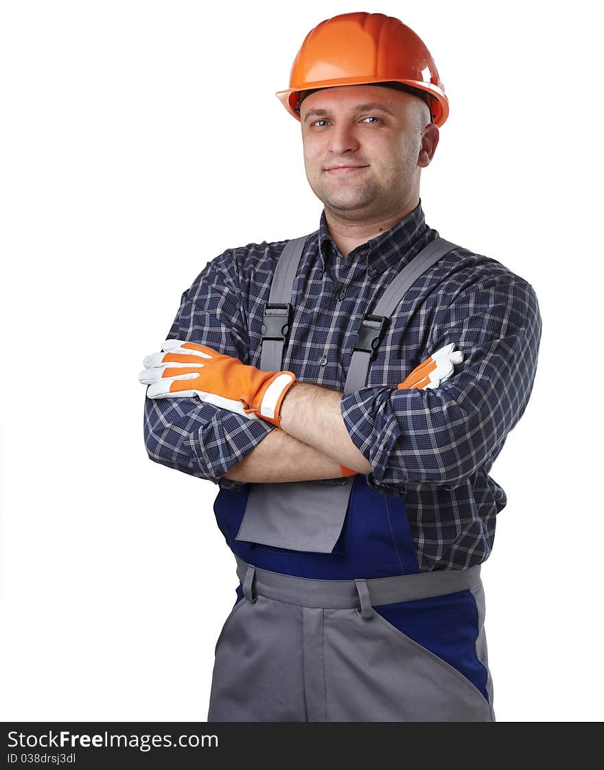 The man in the workers' clothes in a helmet on a white background. The man in the workers' clothes in a helmet on a white background