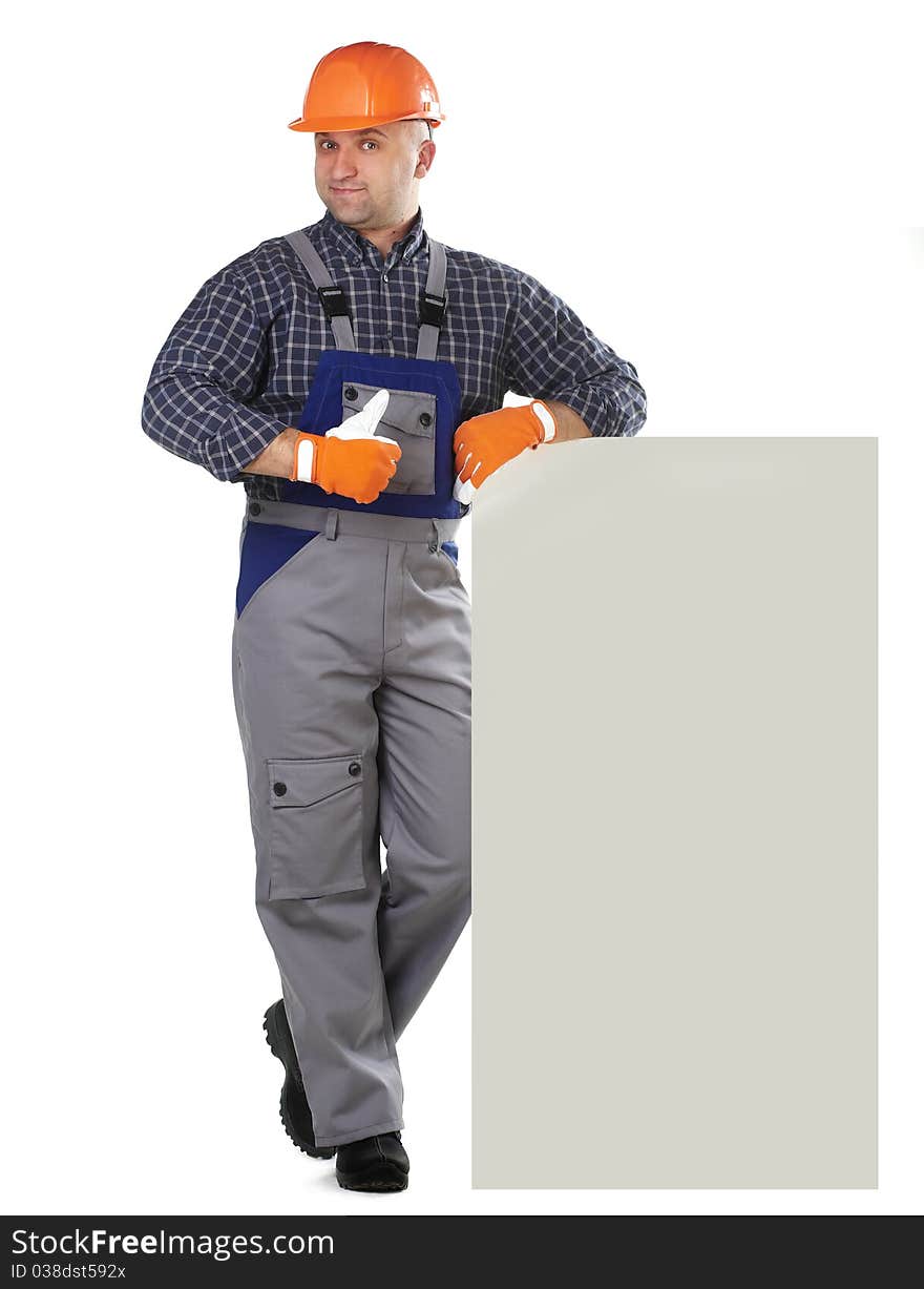 The man in the workers' clothes in a helmet on a white background. The man in the workers' clothes in a helmet on a white background