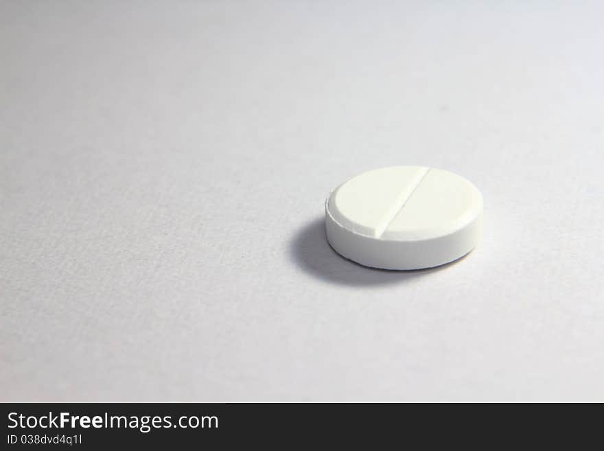 A macro shot of medicines, white tablets. A macro shot of medicines, white tablets