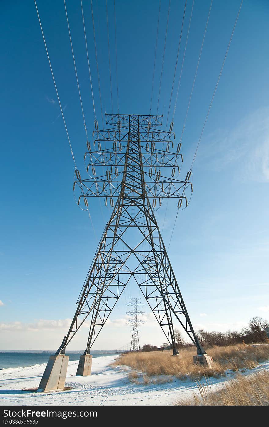 Electrical Tower (Electricity Pylon) beside a lake