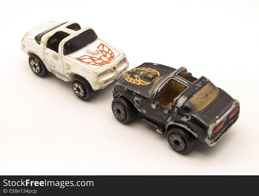 Face to face old toy cars with white background