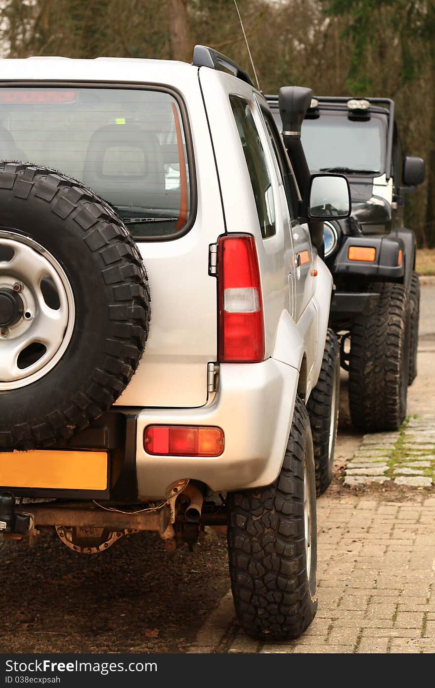 Image of two offroad cars in the country