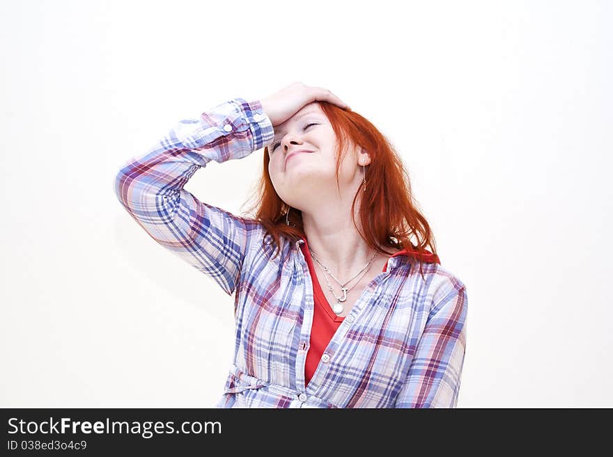 Redhead young woman holding her hand to the head