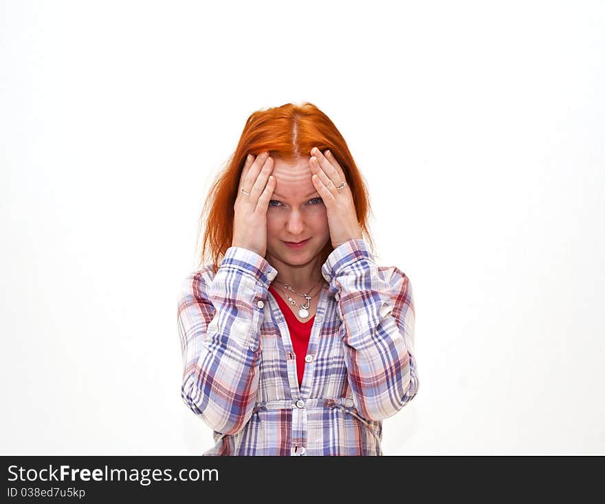 Redhead young woman holding her hand to the head