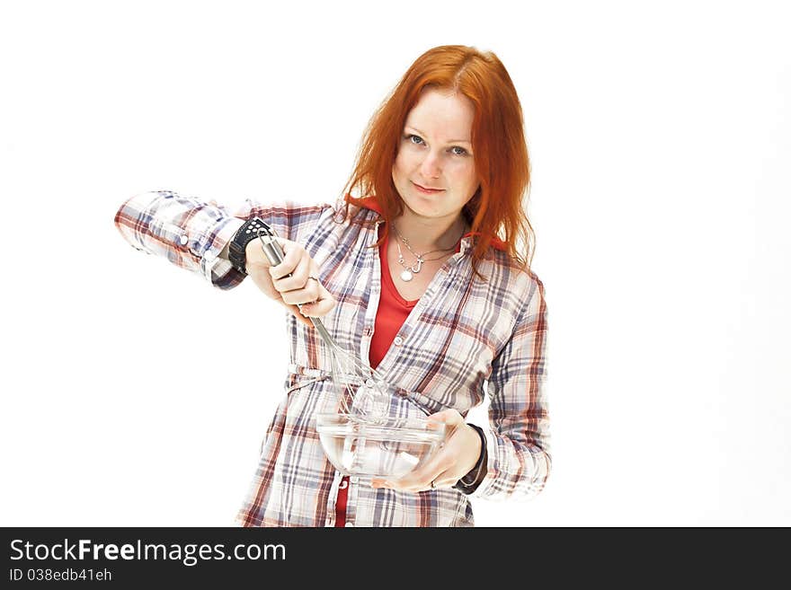 Redhead young woman cooks dinner isolated on white